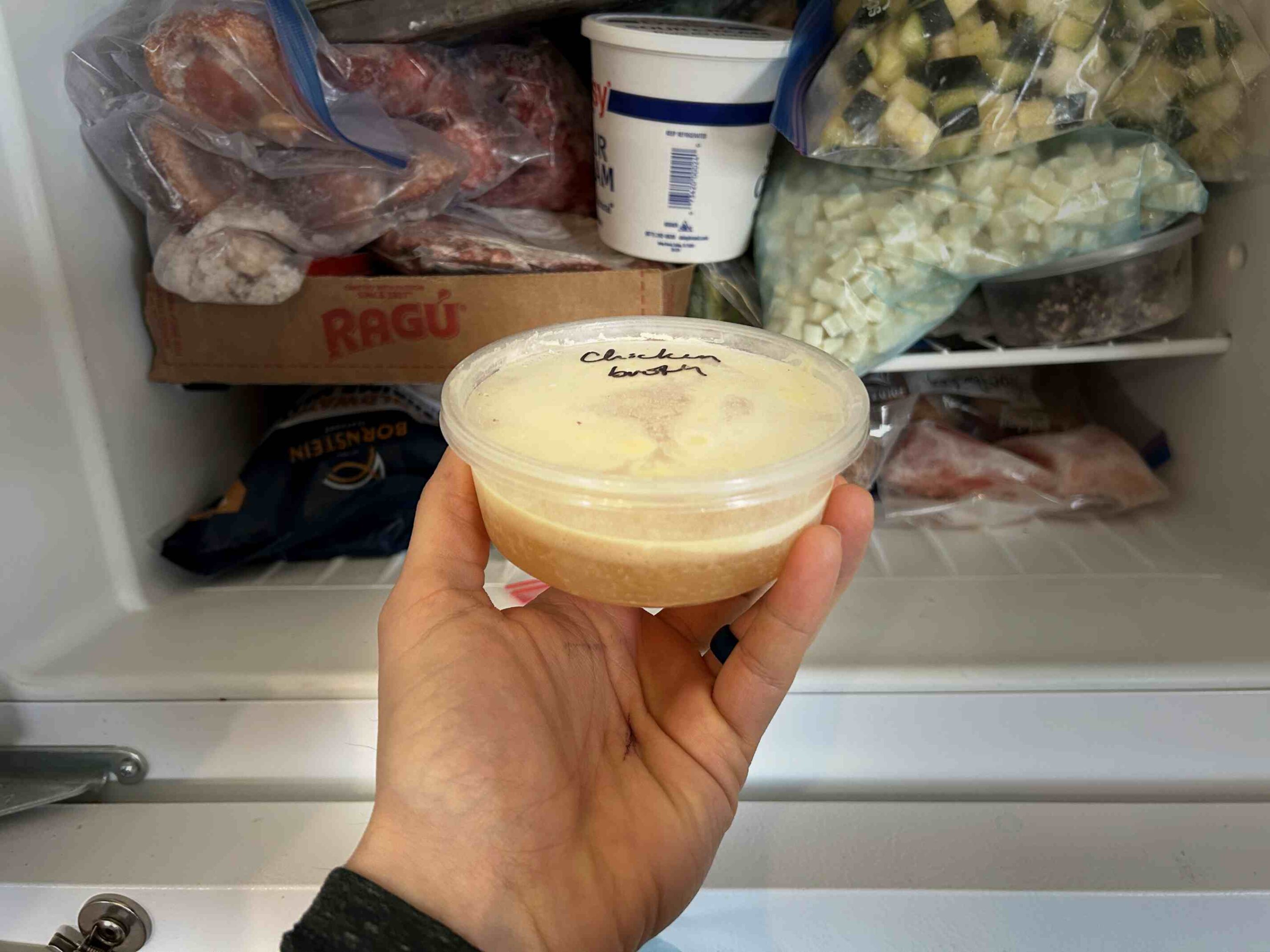 Frozen container of chicken bone broth
